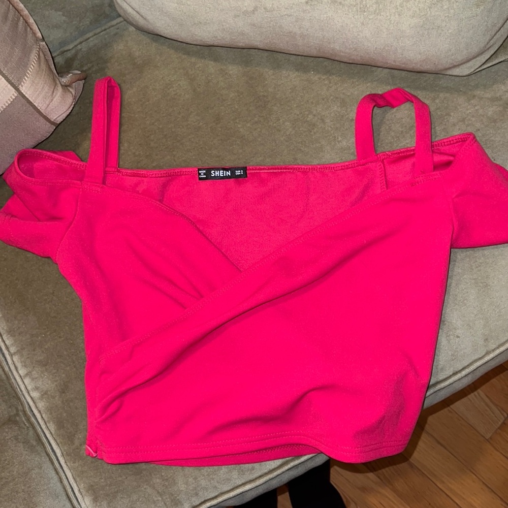 A neon pink off the shoulder top